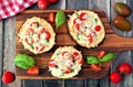 Healthy eggplant pizzas with melted mozzarella, tomatoes and basil