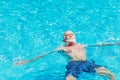 Healthy elder enjoy relax swimming in the swimming pool alone vacation holiday