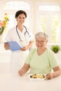 Healthy elderly woman eating salad Royalty Free Stock Photo