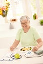 Healthy elderly woman eating salad Royalty Free Stock Photo