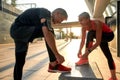 Healthy family. Active middle-aged couple in sports clothing tying shoelaces before jogging outdoors. Exercising Royalty Free Stock Photo