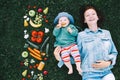 Healthy family nutrition. Mother and baby with fruits and vegetables.