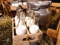 Healthy farm products. Aluminum cans and glass bottles with fresh natural milk on the hay in the hayloft of a dairy farm Royalty Free Stock Photo