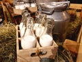 Healthy farm products. Aluminum cans and glass bottles with fresh natural milk on the hay in the hayloft of a dairy farm Royalty Free Stock Photo