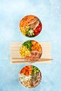 Healthy fast dish, Poke bowls flamed salmon, pulled pork, vegan protein alternative heura, rice, noodles, variety vegetables. Royalty Free Stock Photo
