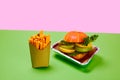 Healthy fast food. Carrots instead friends and vegetable burger against green background. Organic products and healthy Royalty Free Stock Photo