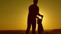 Healthy father and little daughter whirl in dance at sunset. concept of happy childhood. Dad is dancing with child in Royalty Free Stock Photo