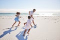 Healthy father and two children playing soccer on the beach. Single dad having fun and kicking ball with his daughter Royalty Free Stock Photo