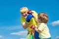 Healthy fighter Grandfather and grandson with boxing gloves. Elderly man hitting punching bag. Handsome elderly man