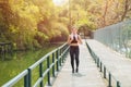Healthy Fit Asian woman running jogging urban outdoor alone in the morning happy smiling