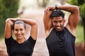 Healthy, fit and motivated couple stretching, warming up or training together in green park with bokeh background. Faces