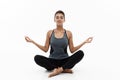 Healthy and Fitness concept - Beautiful American African lady in fitness clothing doing yoga and meditation. Isolated on