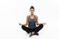 Healthy and Fitness concept - Beautiful American African lady in fitness clothing doing yoga and meditation. Isolated on