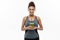 Healthy and Fitness concept - Beautiful American African lady in fitness clothing drinking healthy vegetable drink