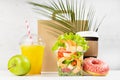 Healthy fitness food set of drinks, tropical shrimp salad in box, donut, packet in white interior with green palm leaf. Mockup.