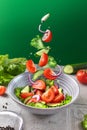 Healthy fitness fresh simple salad levitation. Photo of healthy food Vegetable green salad cucumbers tomatoes onions in Royalty Free Stock Photo