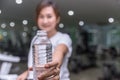 healthy fitness girl smile hand hold give water bottle of drinking water Royalty Free Stock Photo