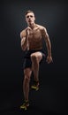 Healthy and fitness man running on black background. Royalty Free Stock Photo