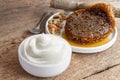 Healthy flavored yogurt in ceramic bowl with granola and honey comb on the wood background. Food and healthy concept