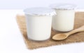 Healthy flavored yogurt in plastic cup with wooden spoon on the