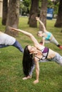 Woman doing yoga triangle pose outdoors