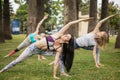 Woman doing yoga triangle pose outdoors