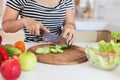 Healthy food Asian woman is cooking salad in kitchen, female preparing vegetables and fruit at her house Royalty Free Stock Photo