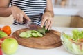 Healthy food Asian woman is cooking salad in kitchen, female preparing vegetables and fruit at her house Royalty Free Stock Photo