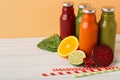 Assortment of detox smoothies in glass bottles on white table background. Royalty Free Stock Photo