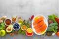 Healthy food background with fresh salmon fish, vegetables, berries and nuts