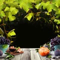 Healthy food background with fruits, green grape leaves and gray wooden table board Royalty Free Stock Photo