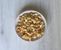 Healthy food for background image close up cashew nuts. Nuts texture on white grey table top view on the cup plate