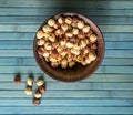 Healthy food for background image close up hazelnuts. Nuts texture on top view on the cup plate