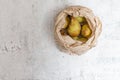 Healthy food background with ripe pears in a beige paper bag