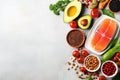 Healthy food. Salmon fish, beans, nuts, avocado and tomatoes on white background. Top view with copy space. AI Generated Royalty Free Stock Photo