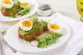 Avocado egg sandwich with whole grain bread on white wooden background Royalty Free Stock Photo