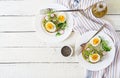 Avocado egg sandwich with whole grain bread on white wooden background. Royalty Free Stock Photo