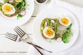 Avocado egg sandwich with whole grain bread on white wooden background. Royalty Free Stock Photo