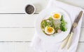 Avocado egg sandwich with whole grain bread on white wooden background. Royalty Free Stock Photo