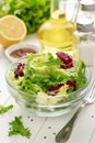 Healthy food for breakfast: fresh mixed salad with flax seeds on wooden background.