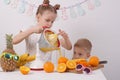 Healthy food for children: A girl and a boy are making orange juice Royalty Free Stock Photo