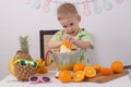 Healthy food for children: A girl and a boy are making orange juice Royalty Free Stock Photo