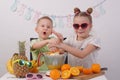 Healthy food for children: A girl and a boy are making orange juice Royalty Free Stock Photo