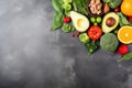 Healthy food clean eating selection. Fresh vegetables, fruits and nuts on stone background. Top view with copy space, Healthy food