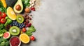 Healthy food clean eating selection: fruit, vegetable, seeds, superfood, cereal, leaf vegetable on gray concrete background