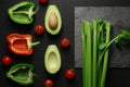 Healthy food clean eating selection on gray background. Green and red bell pepper, avocado, celery and tomatoes. Top view Royalty Free Stock Photo