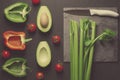 Healthy food clean eating selection on gray background. Green and red bell pepper, avocado, celery and tomatoes. Top view Royalty Free Stock Photo