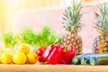 Healthy food collection. Juicy fresh fruits and vegetables. Lemons, paprika bell pepper, pineapples and marrow on wooden table. Se Royalty Free Stock Photo