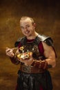 Portrait of medieval person, young man, warrior or knight in war equipment isolated on vintage dark background Royalty Free Stock Photo