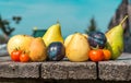 Healthy food composition, apples, pears, plums and tomatoes on rustic wooden table Royalty Free Stock Photo